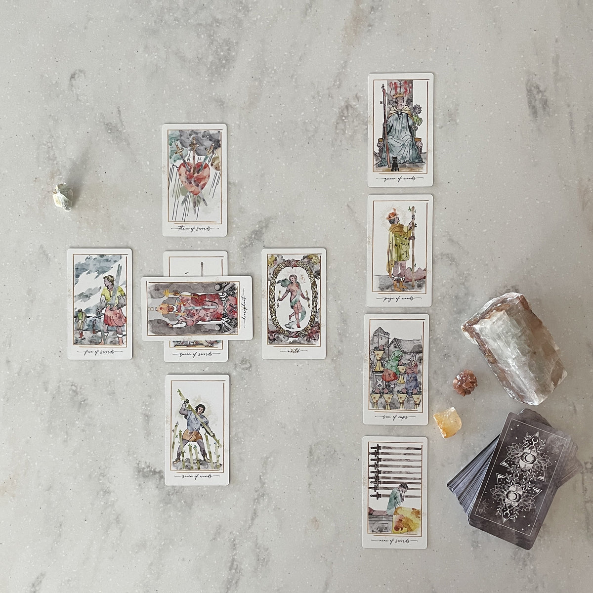 Modern Hue Tarot deck: Rider-Waite-Smith cards recolored in soft watercolor, fanned on a table (image 4)