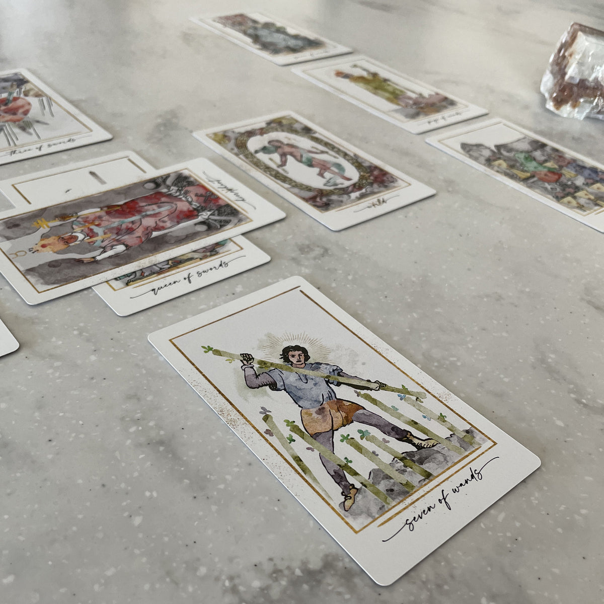 Modern Hue Tarot deck: Rider-Waite-Smith cards recolored in soft watercolor, fanned on a table (image 6)