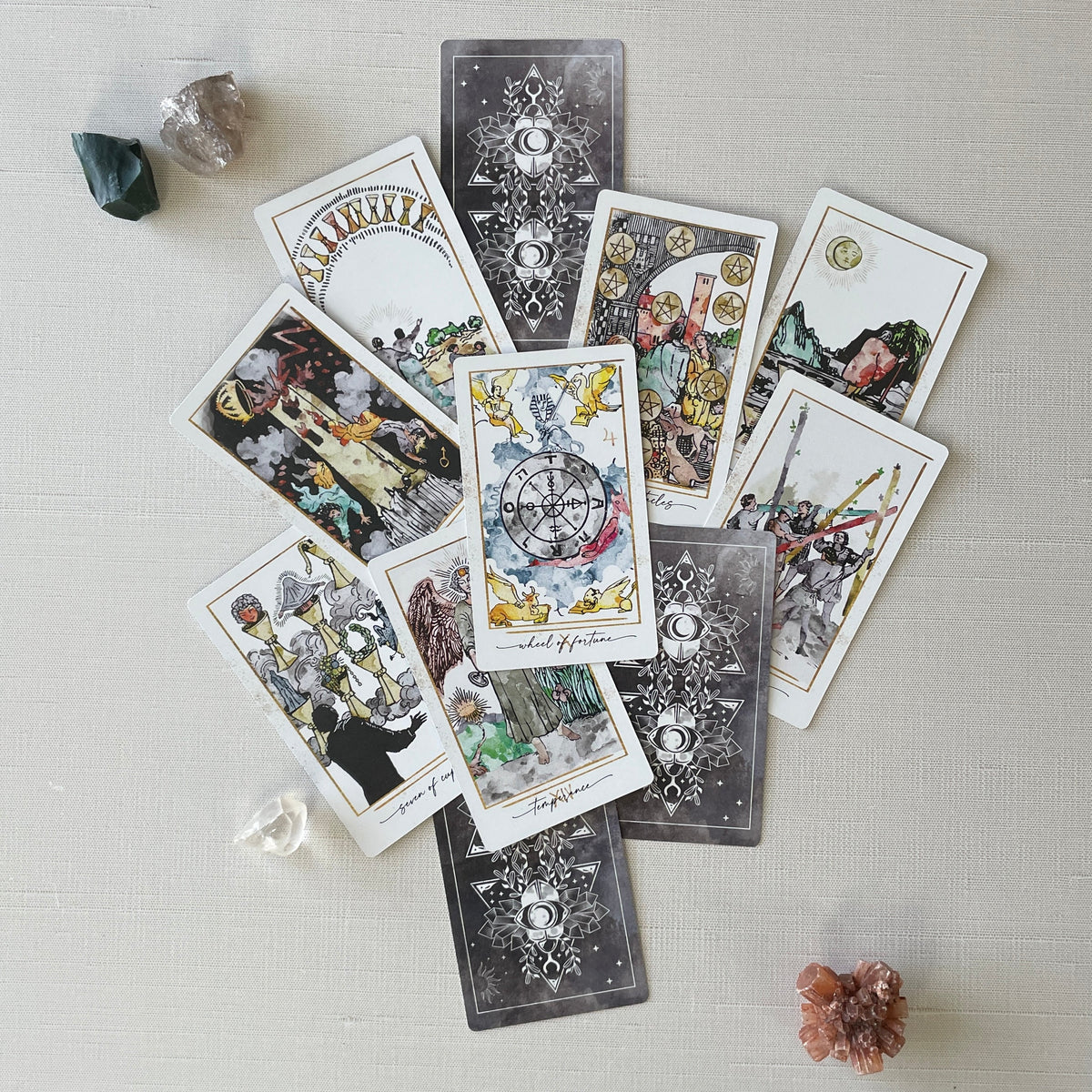 Modern Hue Tarot deck: Rider-Waite-Smith cards recolored in soft watercolor, fanned on a table (image 3)