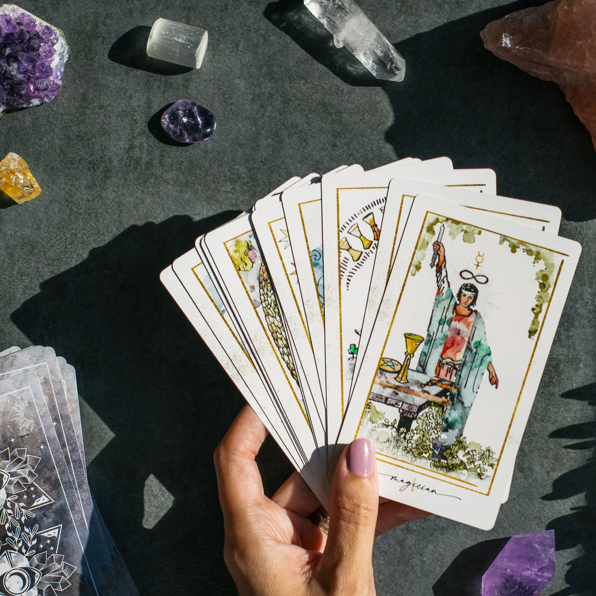 Modern Hue Tarot deck: Rider-Waite-Smith cards recolored in soft watercolor, fanned on a table